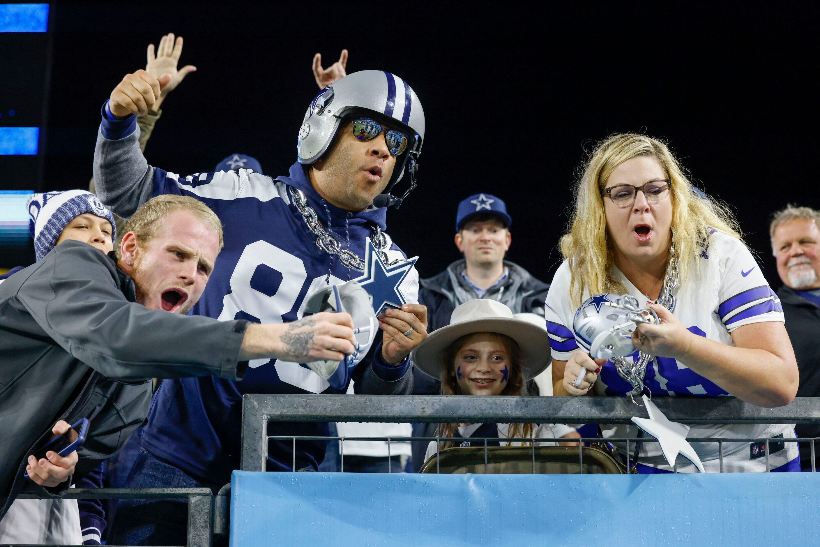 Dallas Cowboys fans cheer as players walk to the locker room before an NFL game against the...