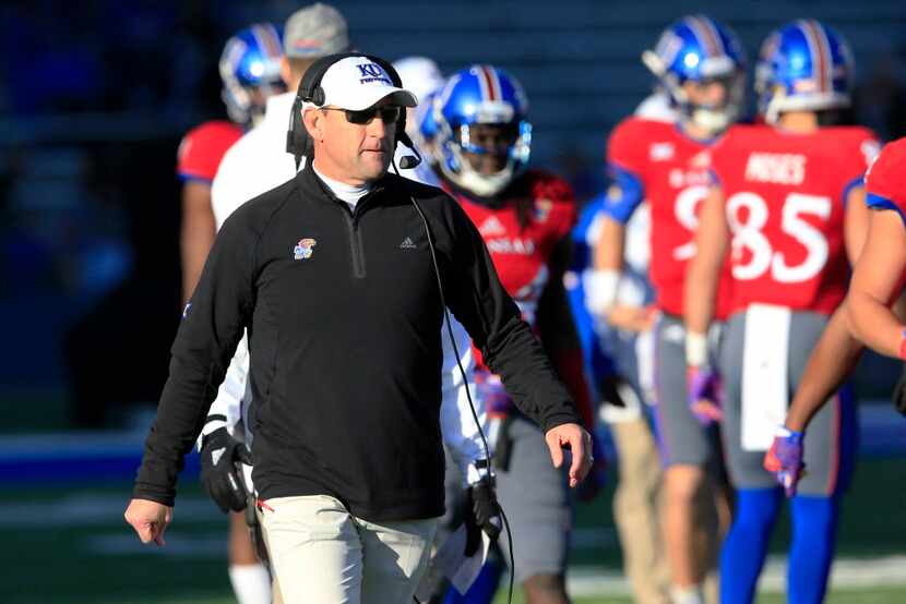 FILE - In this Nov. 19, 2016, file photo, Kansas coach David Beaty stands near players...