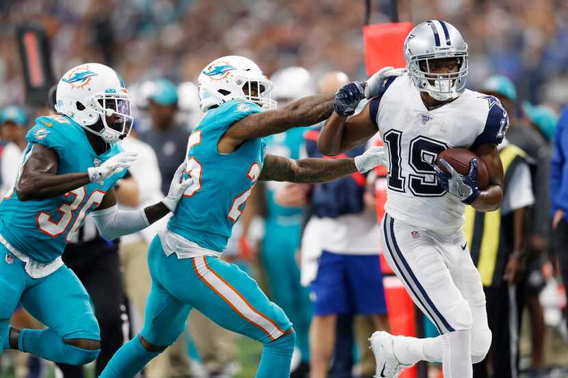 Dallas Cowboys wide receiver Amari Cooper (19) is pushed out of bounds during the second...