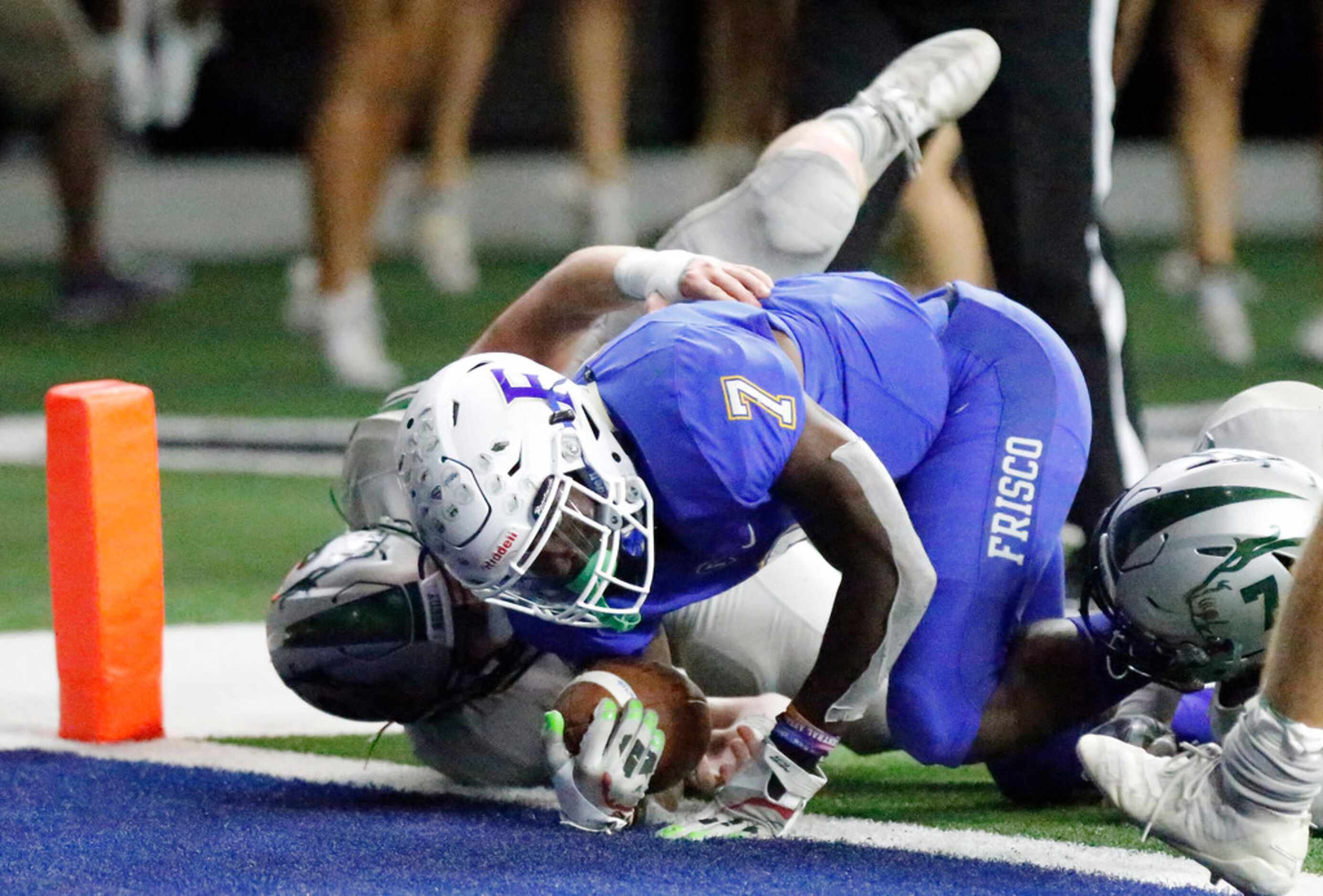 Frisco High School Bryson Clemons (7) lunges over the goal line for the go ahead score...