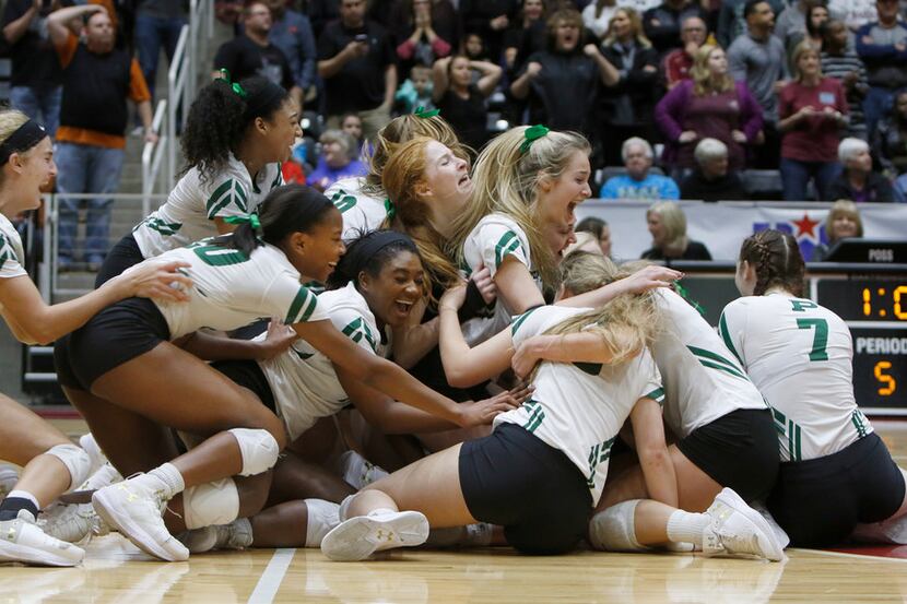 Members of the Prosper volleyball team storm the court and celebrate their come-from-behind...
