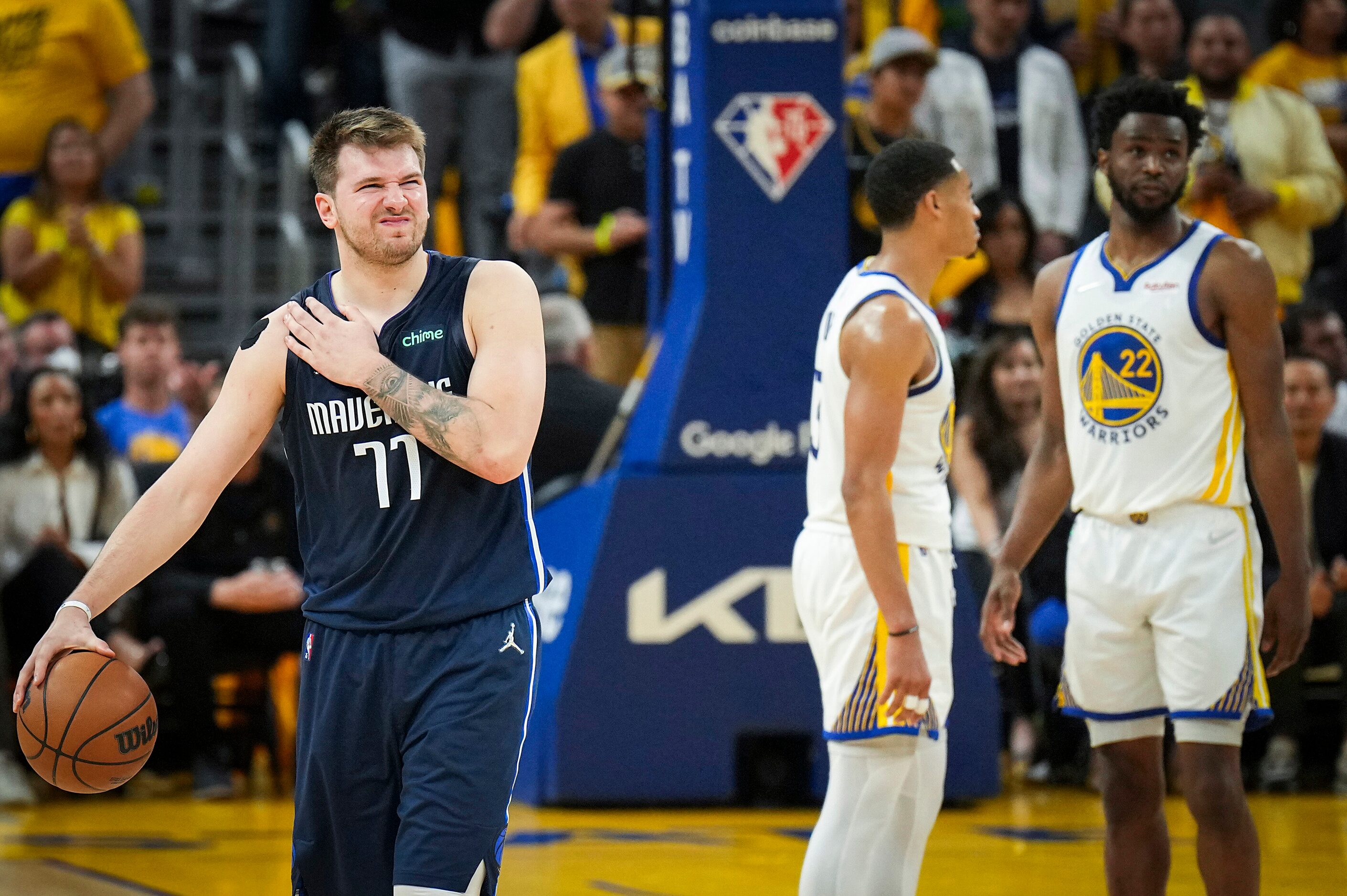 Dallas Mavericks guard Luka Doncic (77) grabs his right shoulder after being fouled by...