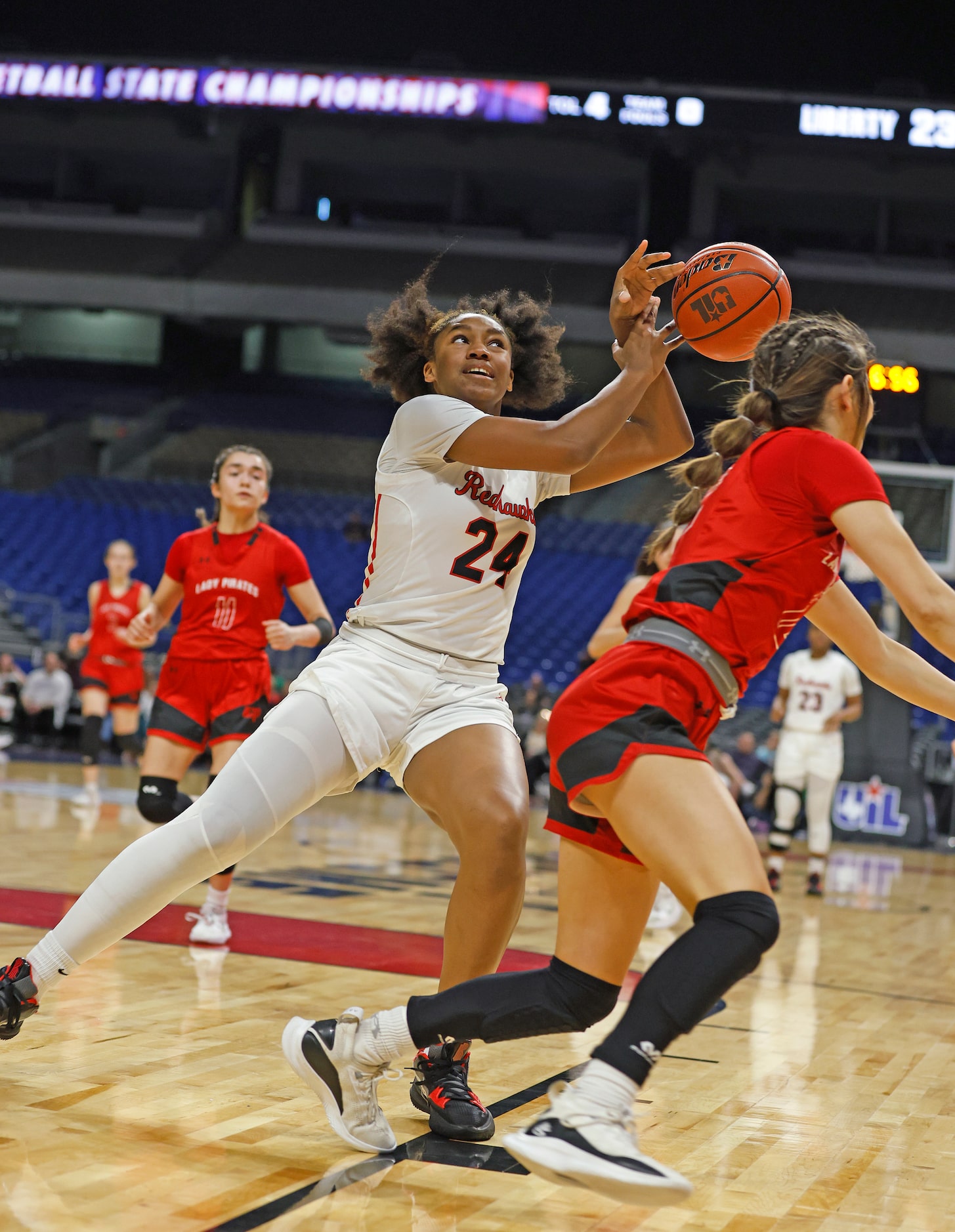 Frisco Liberty Jacy Abrii (24) manages to prevent Lubbock Cooper Majik Esquivel (12) from...