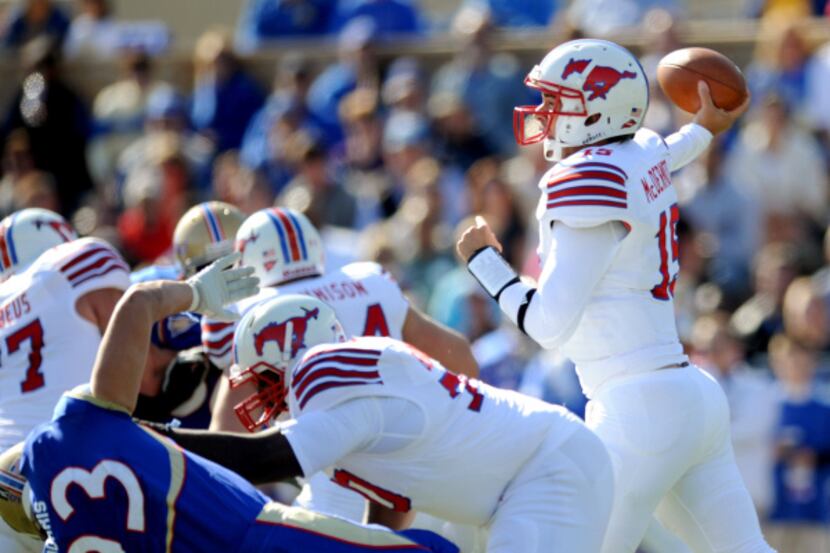 SMU quarterback J.J. McDermott (right) passes in the first quarter against Tulsa in a...