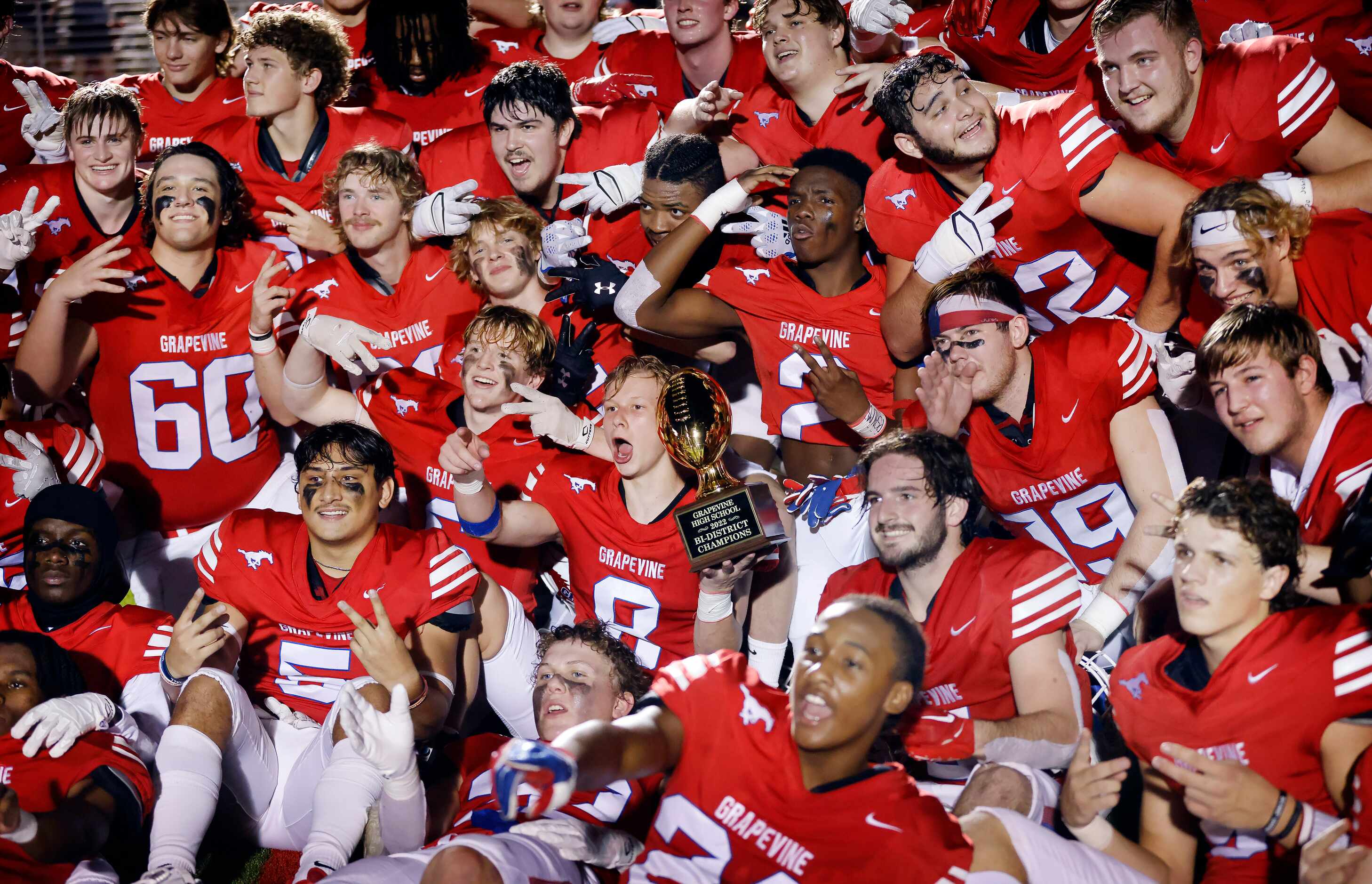 Grapevine football players celebrate their Class 5A bi-district playoff win over Lake Dallas...