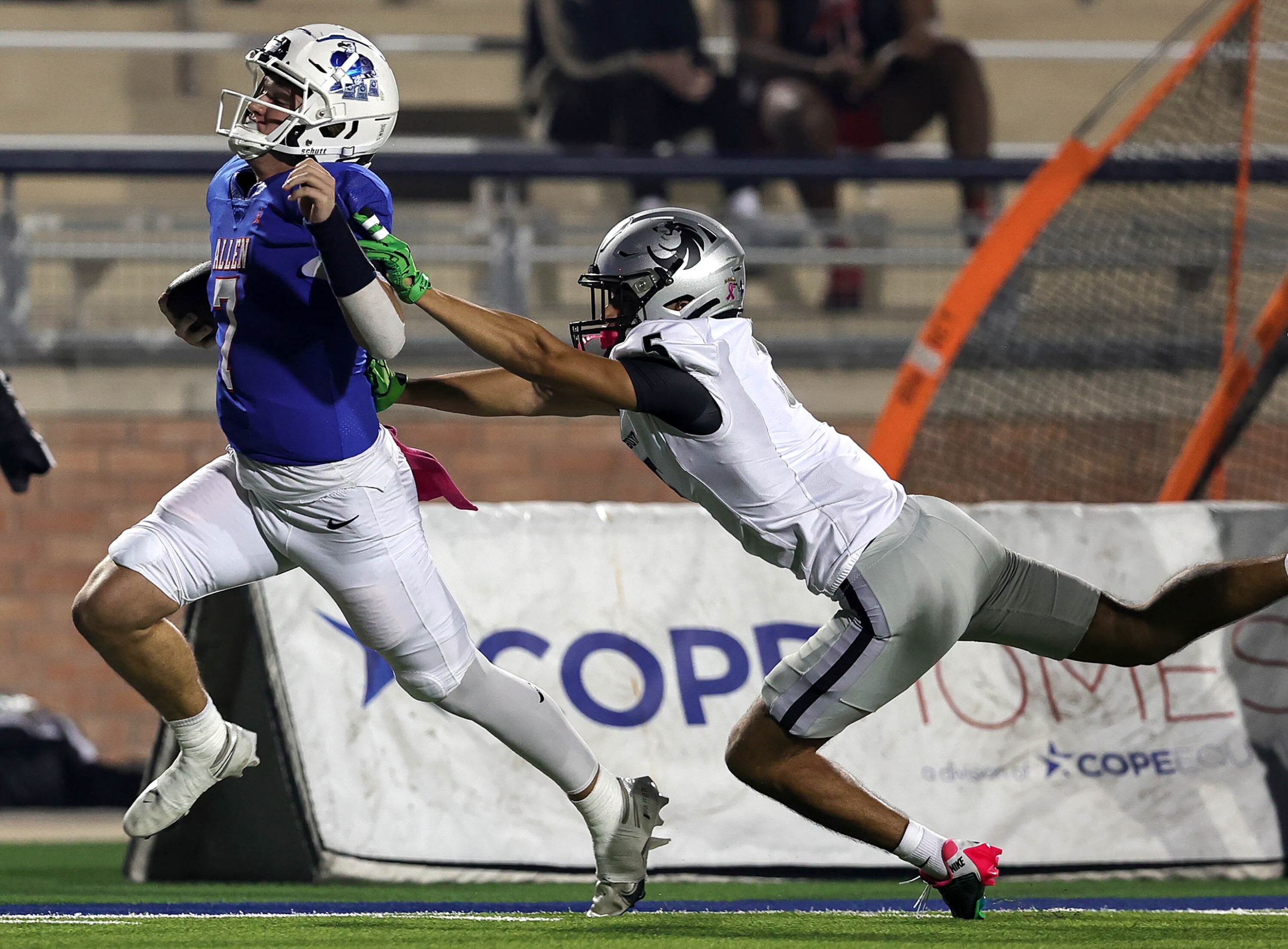 Allen quarterback Brady Bricker (7) makes a nice run and is forced out of bounds by Denton...