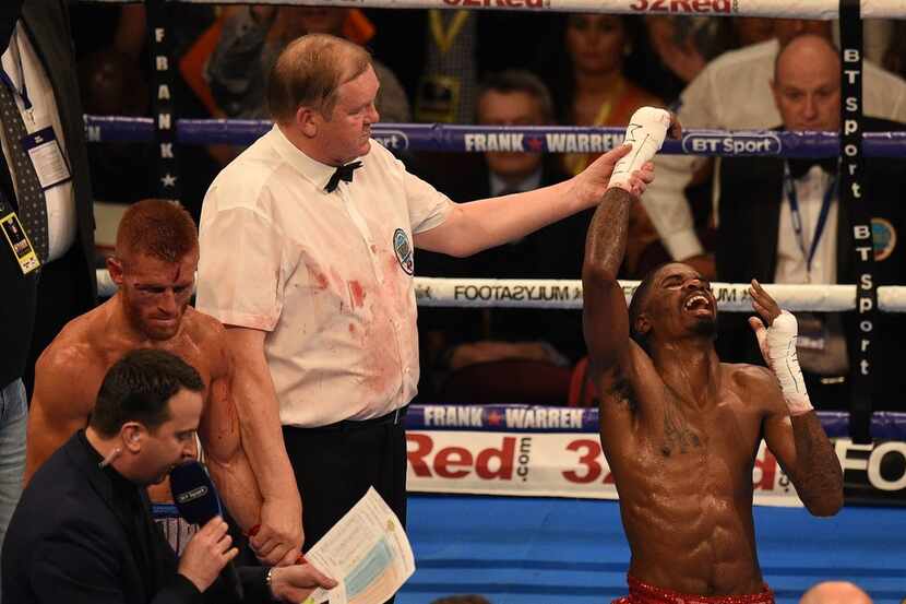 US boxer Maurice Hooker (R) celebrates victory over Britain's Terry Flanagan (L) following...
