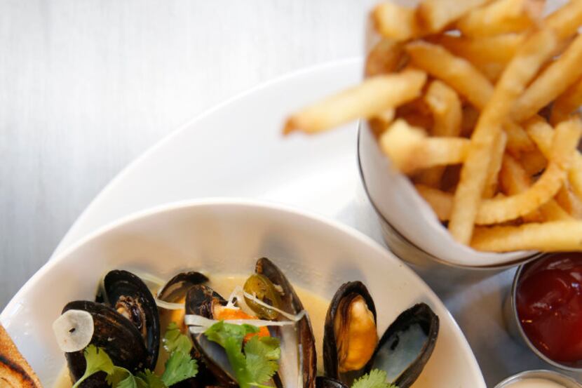 Mussels and fries with granny smith apple, bacon, cider, serrano chili and roasted garlic...