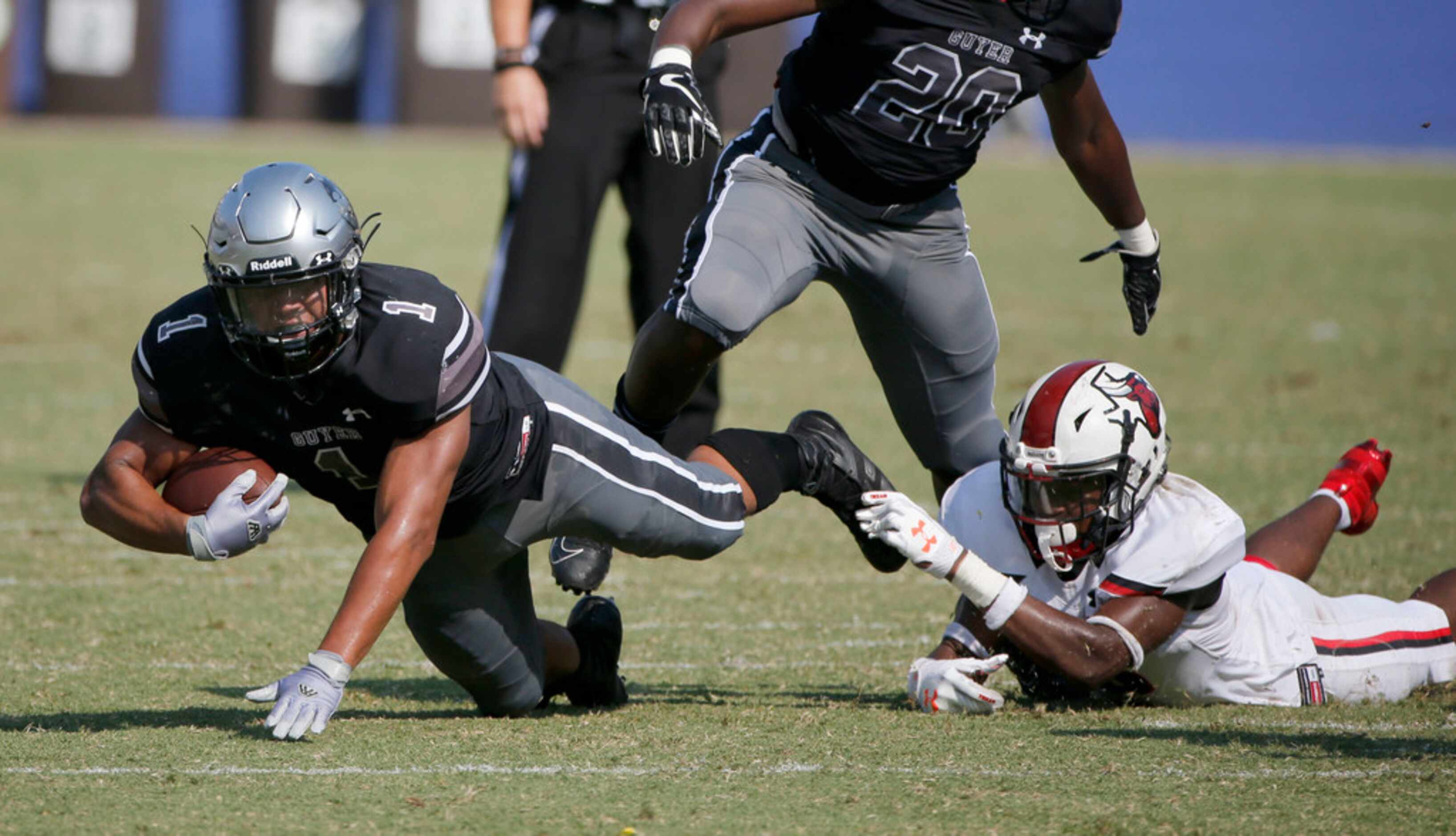 Denton Guyer running back Kaedric Cobbs (1) is tackled by Cedar Hill defender Brett Lynch,...