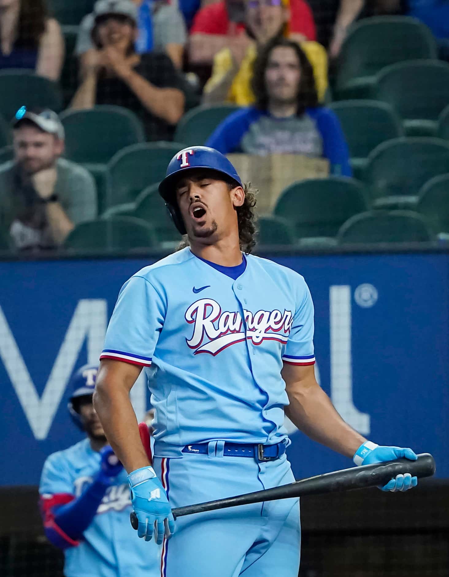 Texas Rangers pinch hitter Ronald Guzman reacts after being called out on strikes with the...