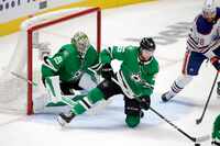 Dallas Stars defenseman Thomas Harley (55) clears the puck after an Edmonton Oilers shot on...