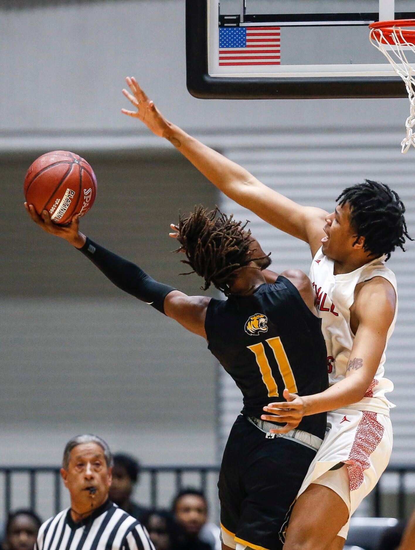 Kimball's Corey Flowers (34) attempts to block a shot by Mount Pleasant's Jamarion Brown...