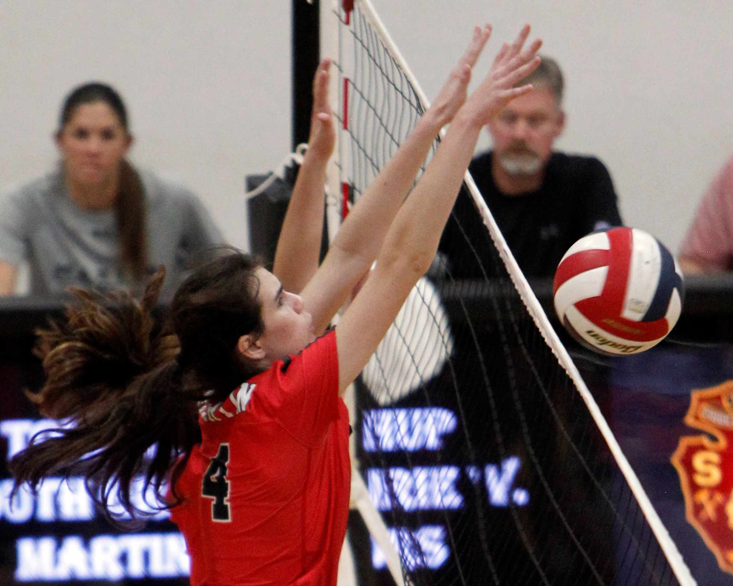 Arlington Martin's Emily Adams (4) denies a shot during the 3rd set of their straight set...