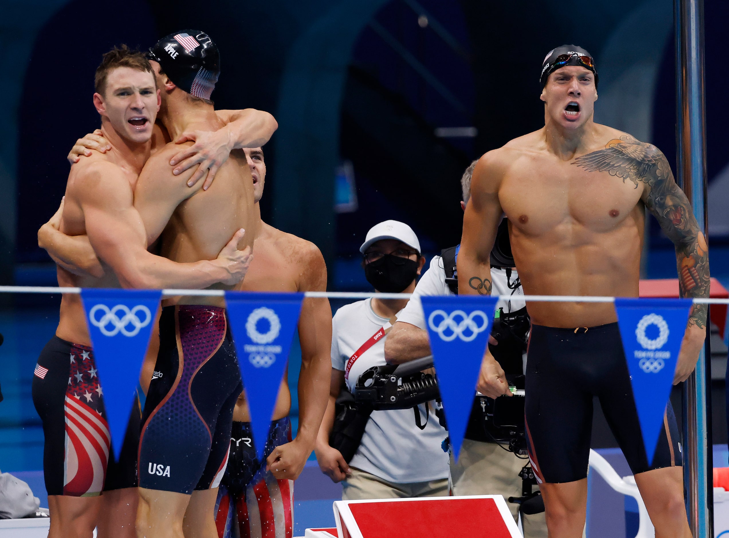 USA’s Ryan Murphy hugs Zach Apple as Michael Andrew and Caeleb Dressel celebrate setting a...