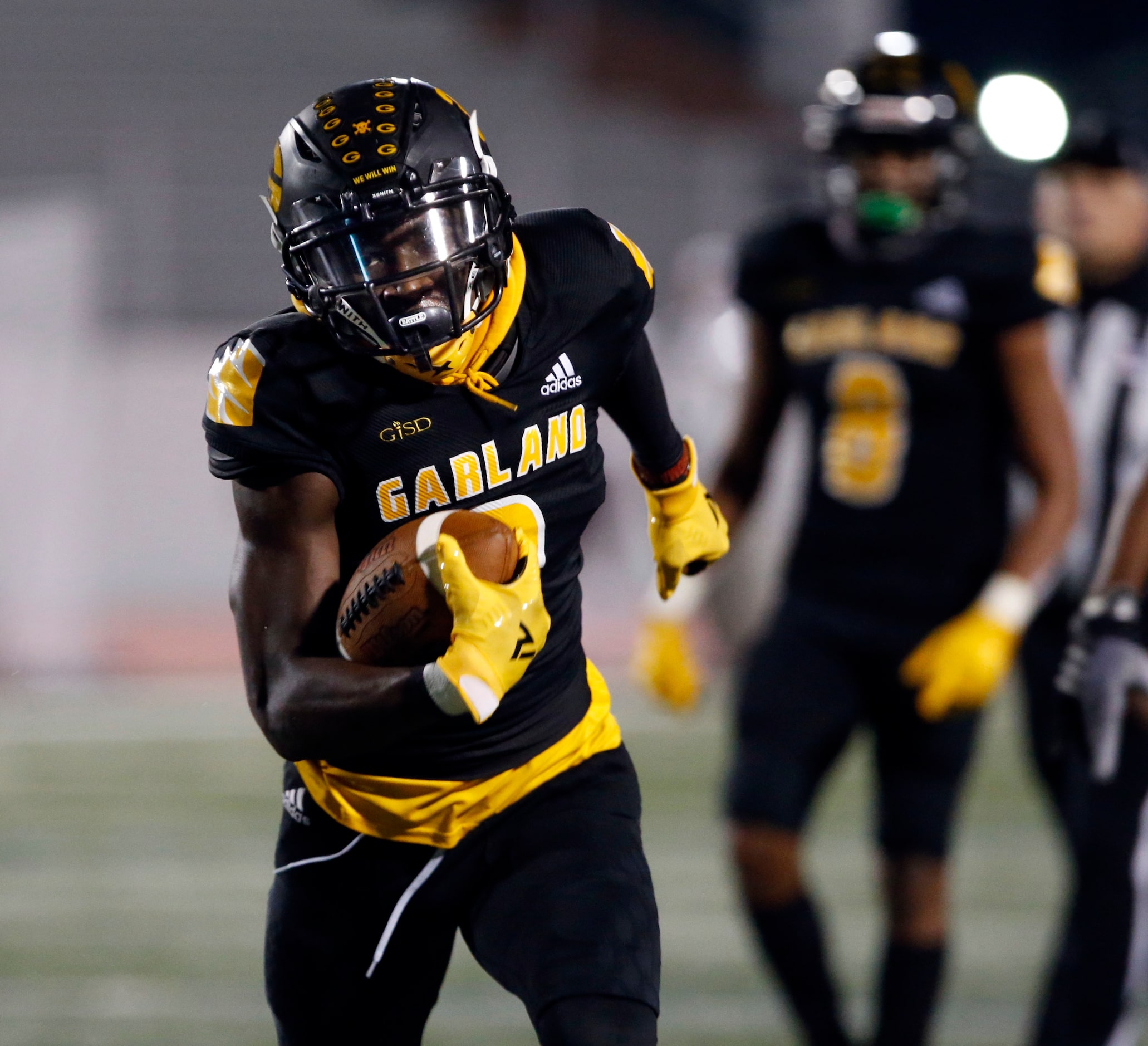 Garland’s Jordan Hudson (3) picks up a couple of yards during the first half of high school...