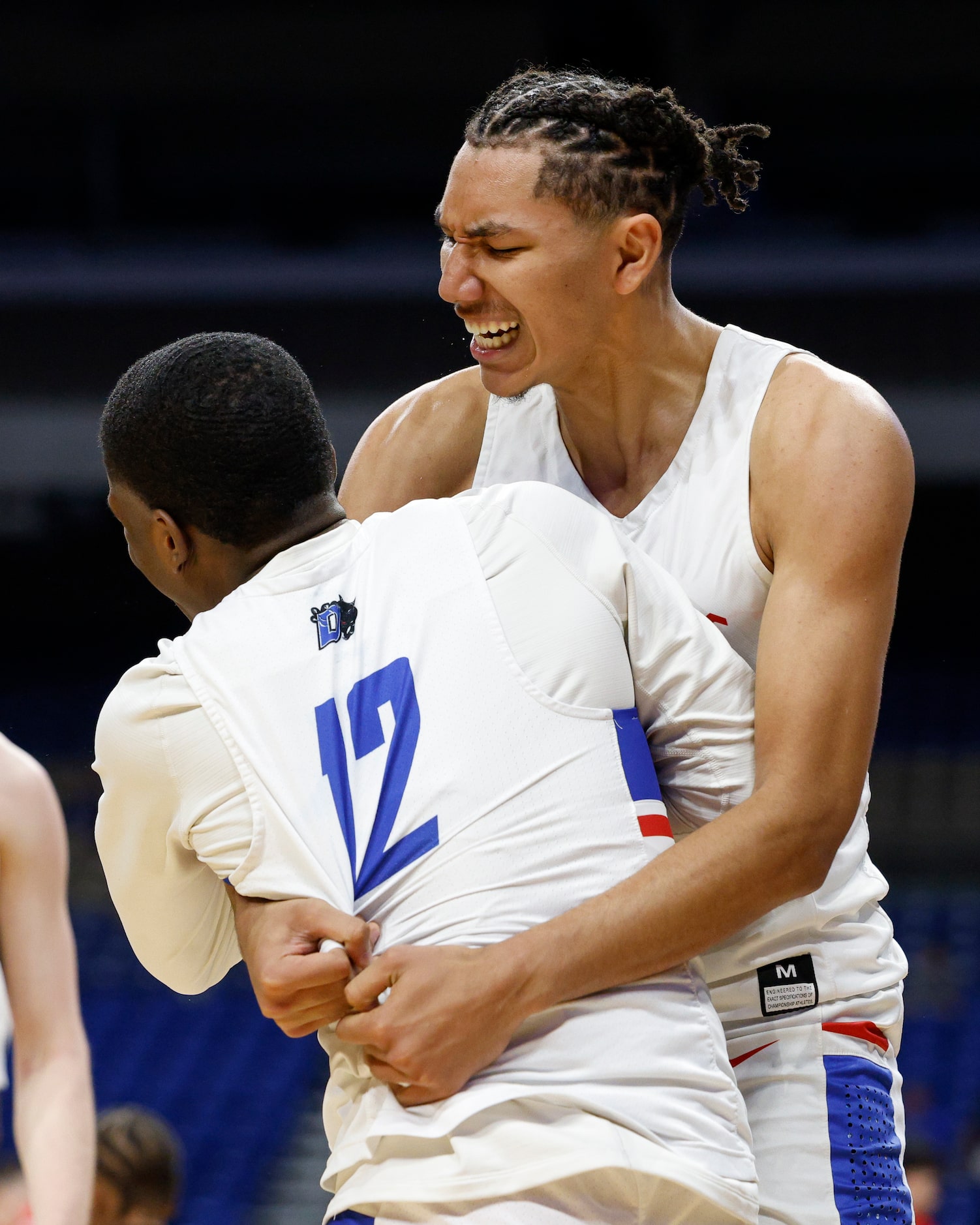 Duncanville forward Davion Sykes (22) celebrates with Duncanville guard Tony Dixon Jr (12)...