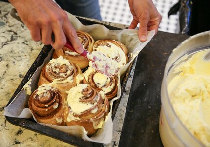 Jupiter House co-owner Joey Hawkins ices cinnamon rolls on Thursday, May 16, 2019 at the...