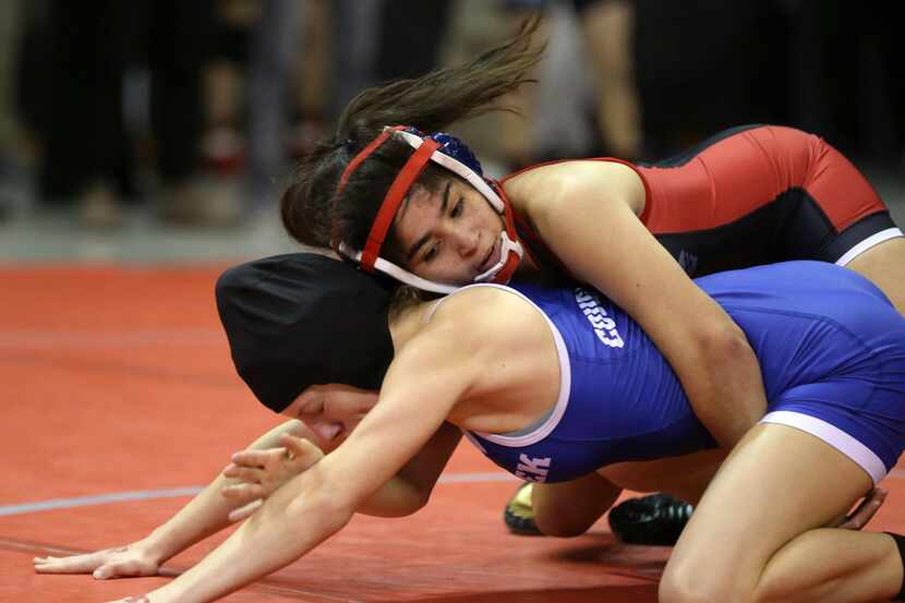 Arlington Martin's Samara Chavez (top) wrestles Cypress Creek's Amanda McAleavey during the...