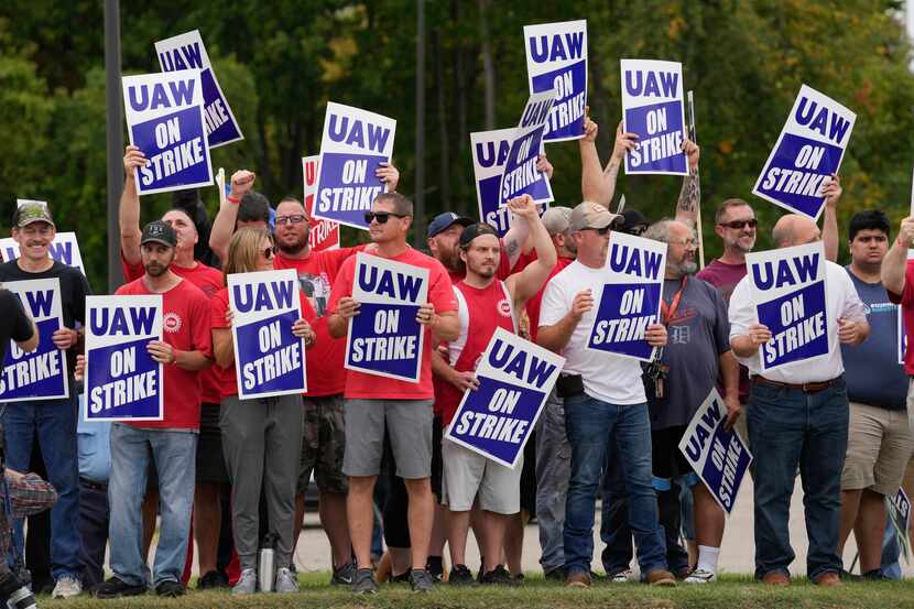 United Auto Workers members hold picket signs near a General Motors Assembly Plant in Delta...