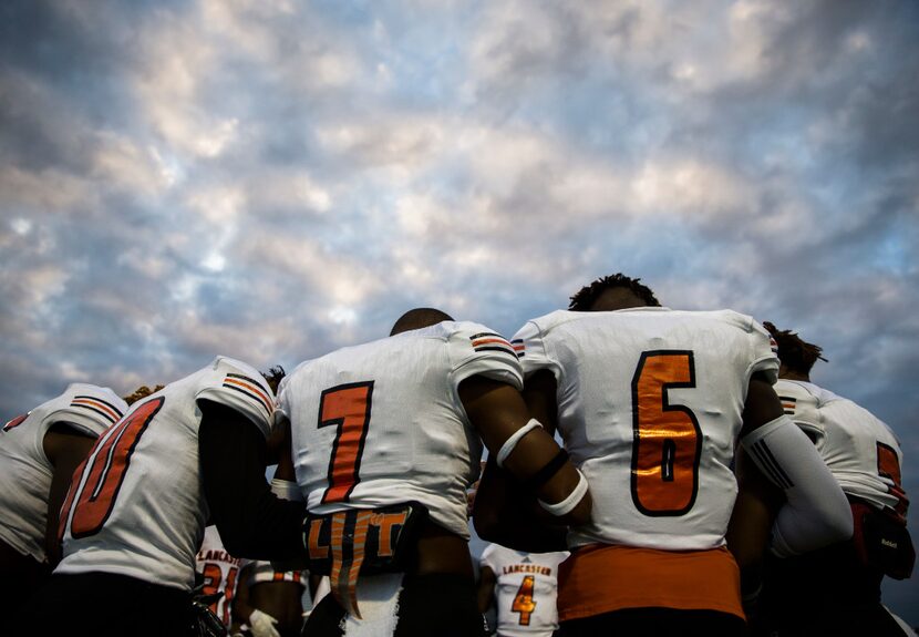 Lancaster football players pray during warmups before their game against Mansfield Summit on...