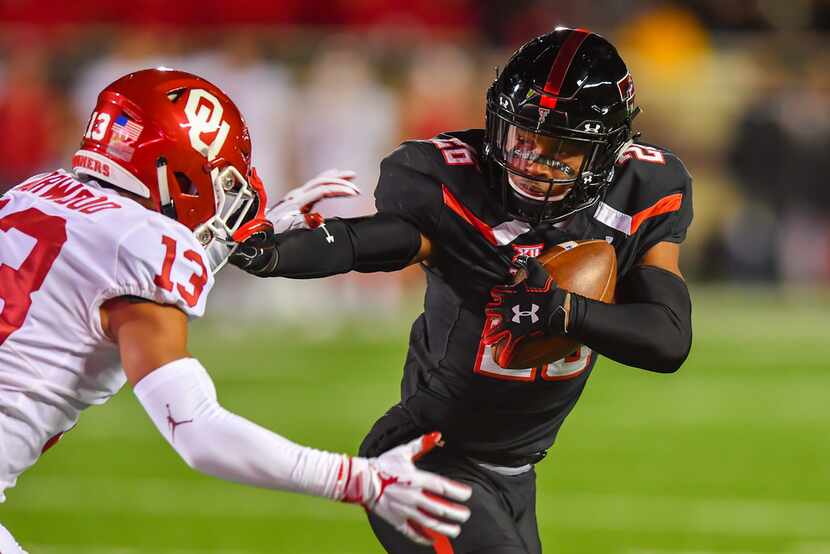 LUBBOCK, TX - NOVEMBER 03: Ta'Zhawn Henry #26 of the Texas Tech Red Raiders gets past Tre...