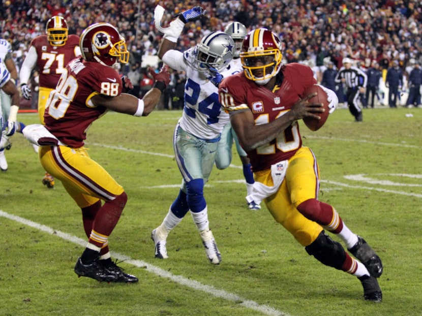 Washington Redskins quarterback Robert Griffin III (10) passes by Dallas Cowboys cornerback...