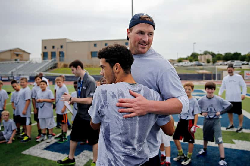 Dallas Cowboys tight end Jason Witten (right) hugs 14-year-old Jacob Rosario of Glendale,...