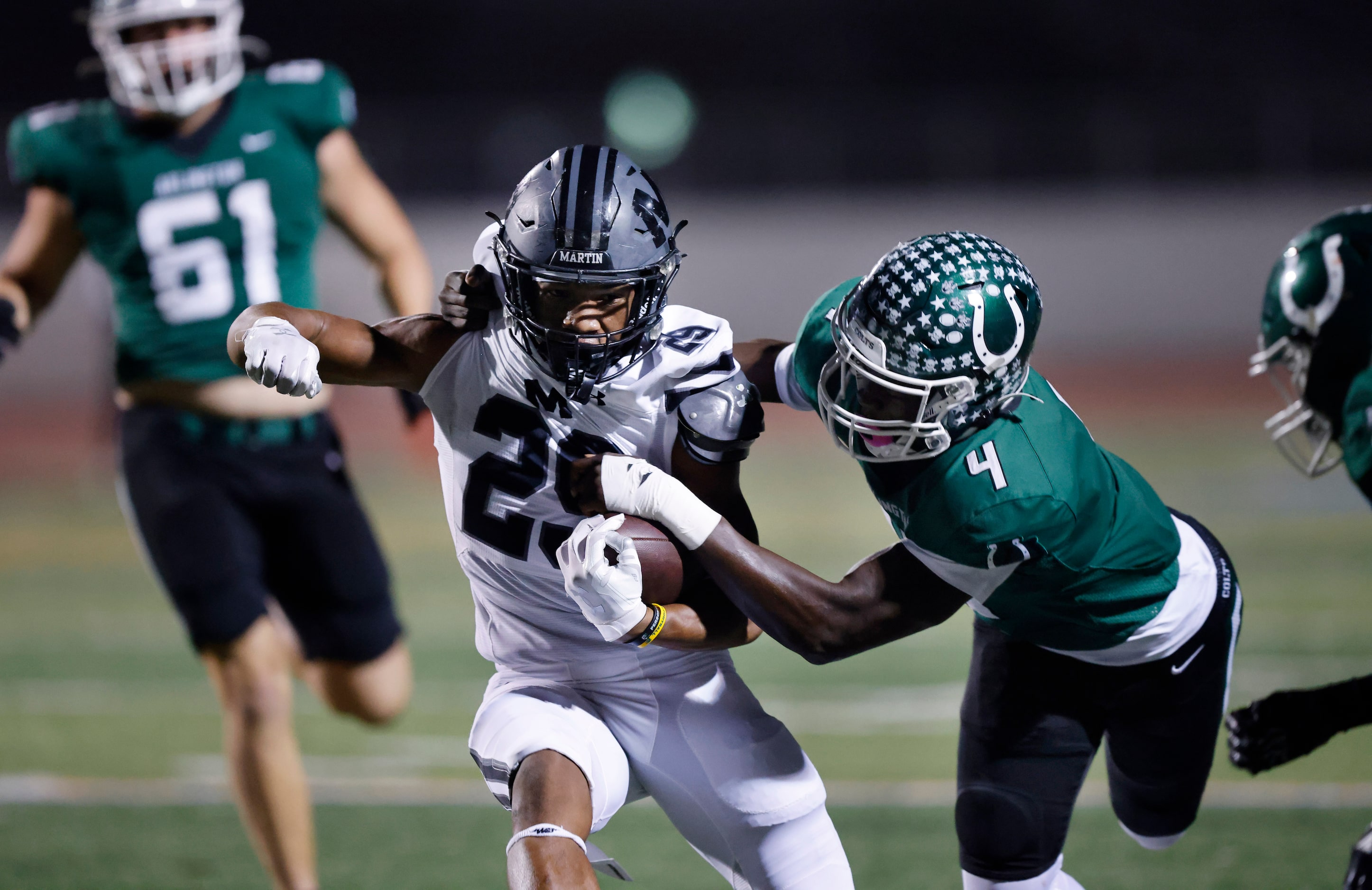 Arlington Martin running back Javian Jones-Priest (29) is tackled by Arlington High...