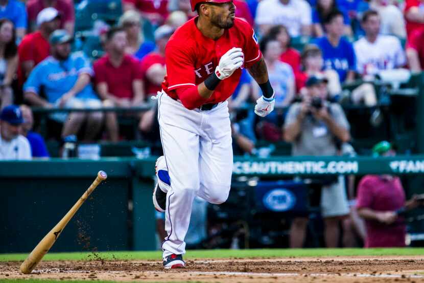 Texas Rangers center fielder Ian Desmond (20) runs to first base during the third inning of...
