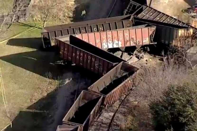 Union Pacific train cars lie scattered after they derailed in Aubrey on Wednesday morning....
