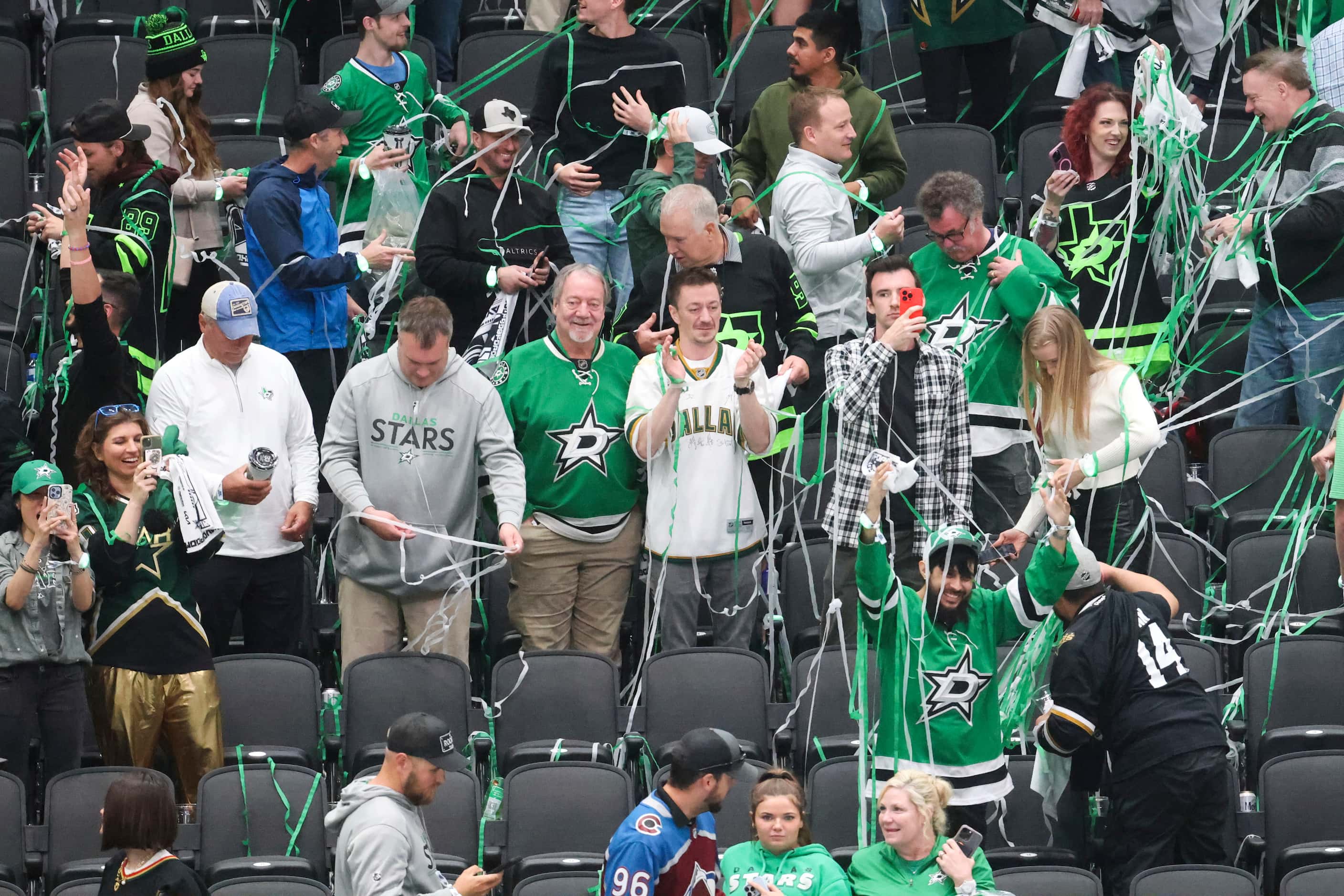 A part of Dallas Stars fans remain covered by confetti following the team’s win in Game 2 of...