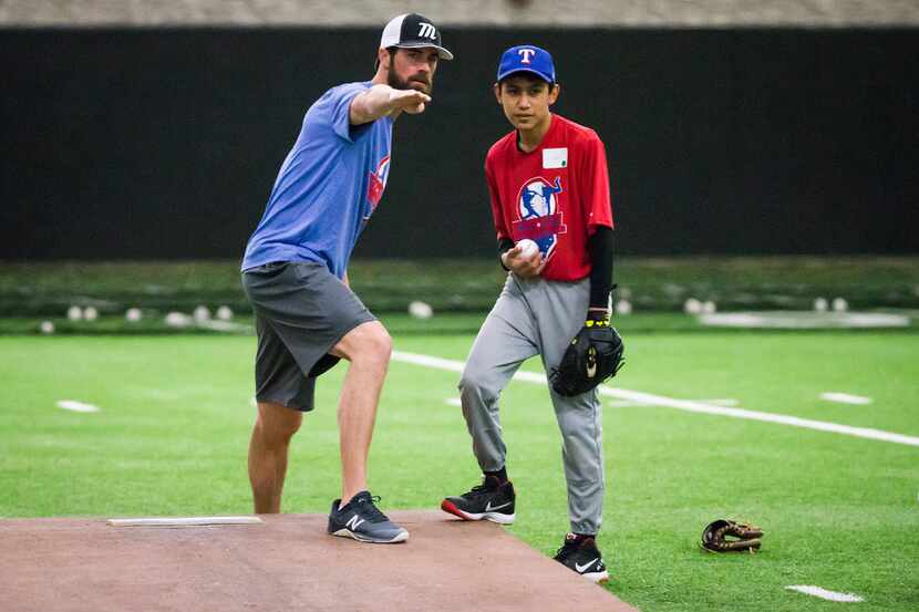 Texas Rangers pitcher Cole Hamels works with a pitcher during during a hitting and pitching...