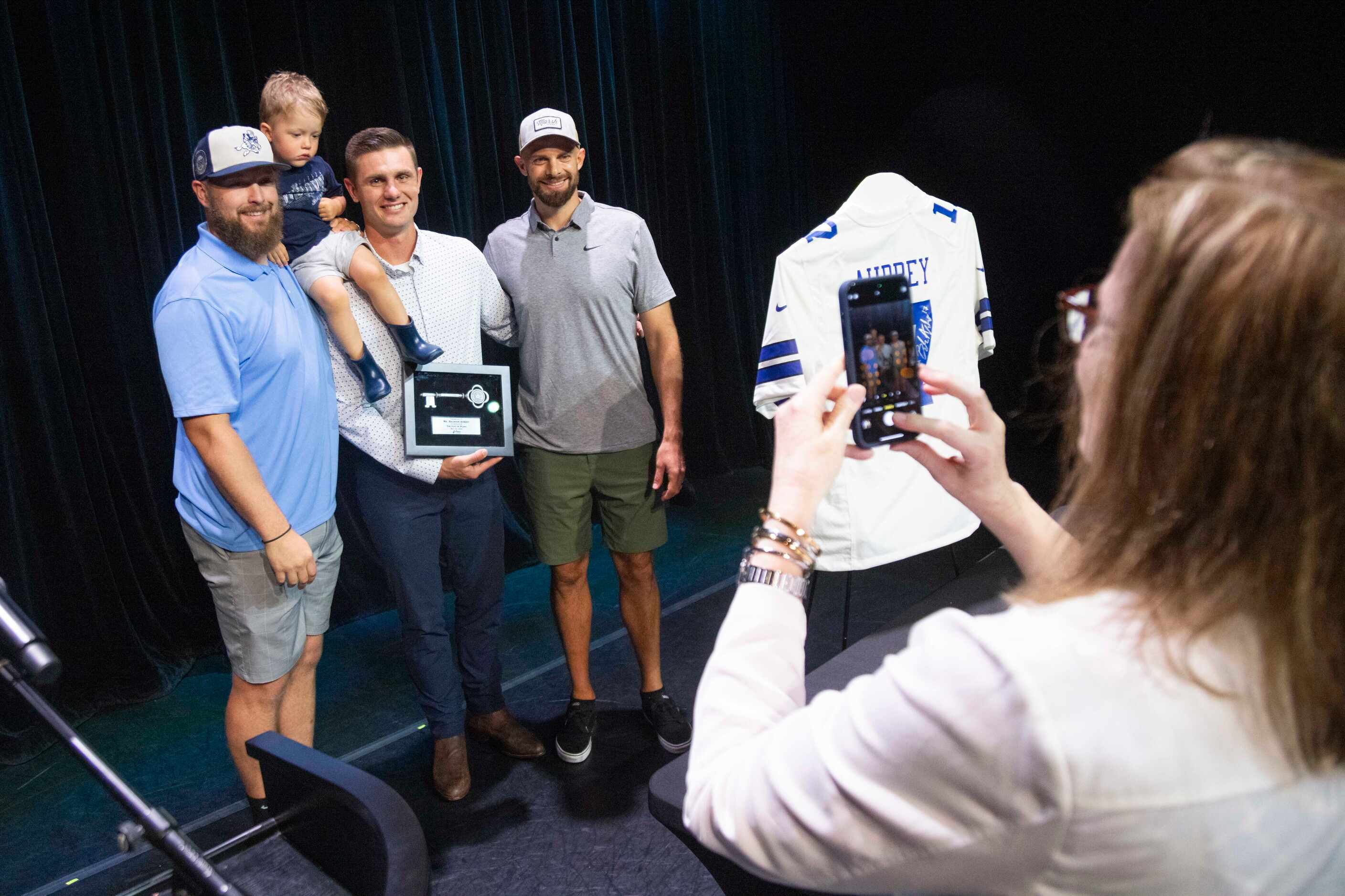 Plano native and Dallas Cowboys kicker Brandon Aubrey, center, poses with fellow Cowboys...