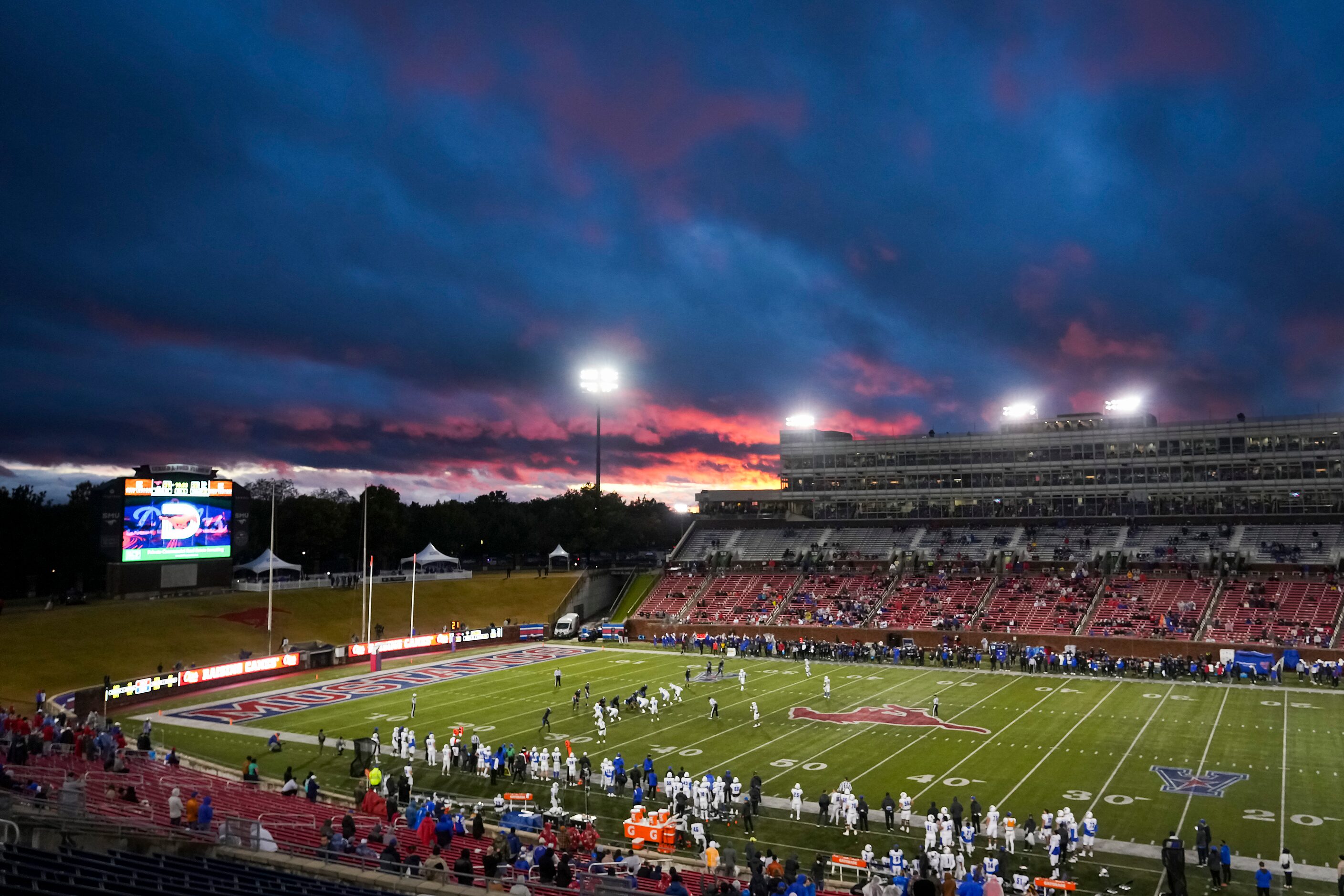 Storm clouds begin to clear over the stadium during the second half of an NCAA football game...