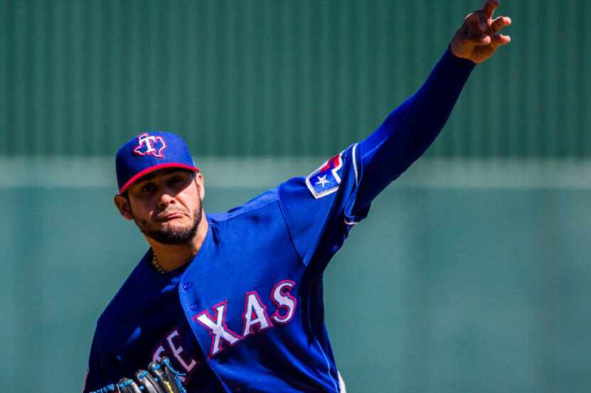 Texas Rangers starting pitcher Martin Perez (33) pitches during the first inning of a spring...