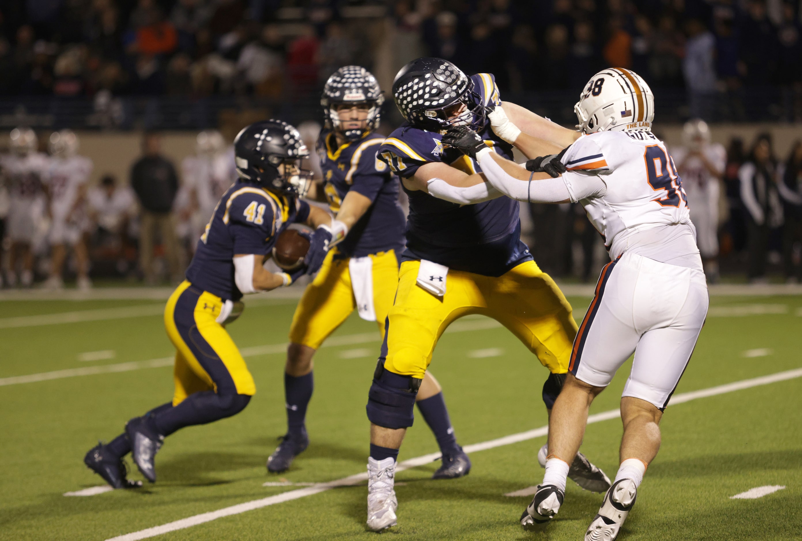 Highland Park's Grayson Davenport (No. 77) blocks Frisco Wakeland's Christian Guevara in a...