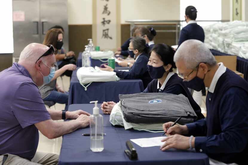 Families displaced in a recent Addison fire receive help at the Tzu Chi foundation in...