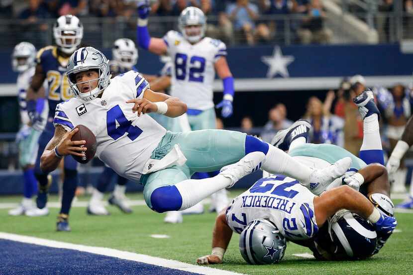 Dallas Cowboys quarterback Dak Prescott (4) scores a two-point conversion but the score was...