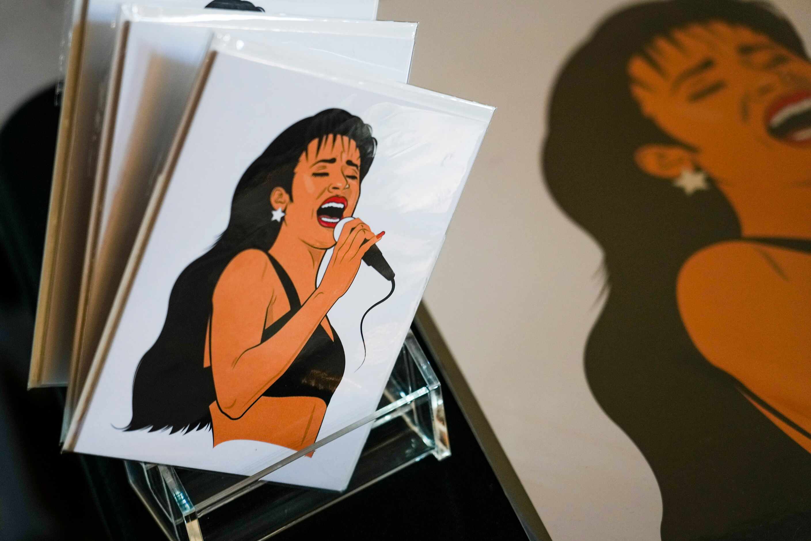 Cars and pictures of Selena Quintanilla-Pérez are seen on a vendor’s table during the...