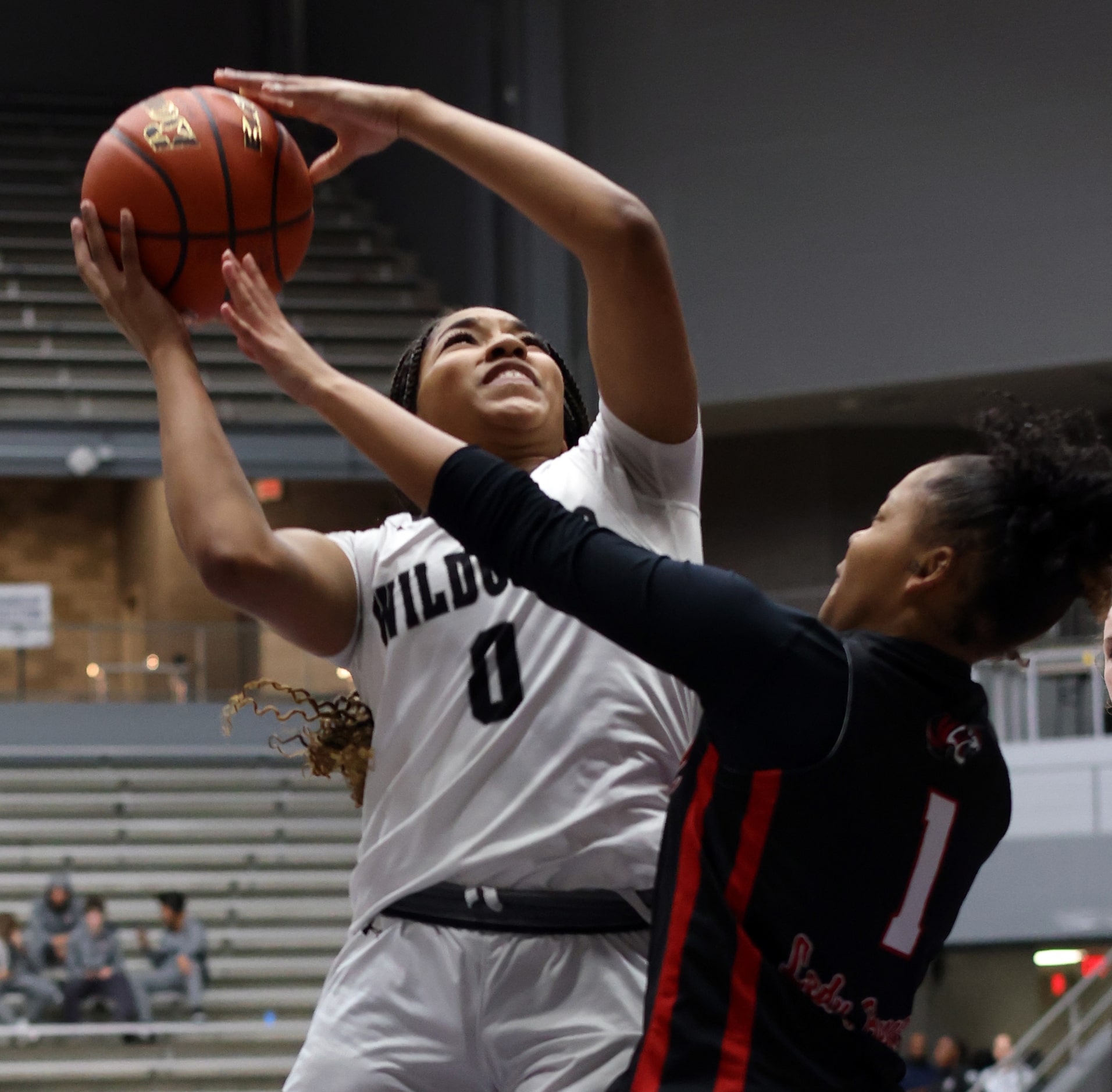 Denton Guyer guard Destine Green (0), left,  puts up a shot over the defense of Denton...