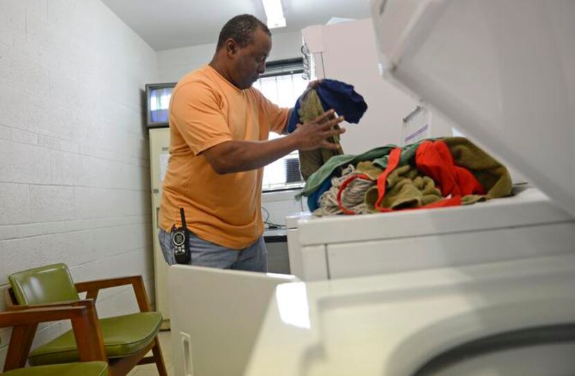 
Michael Allen, a homeless veteran, changes a load of laundry where he works at the Veterans...