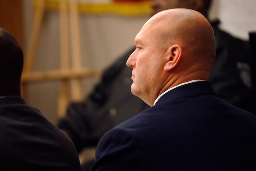 Former Dallas police officer Christopher Hess listens to testimony in his aggravated assault...