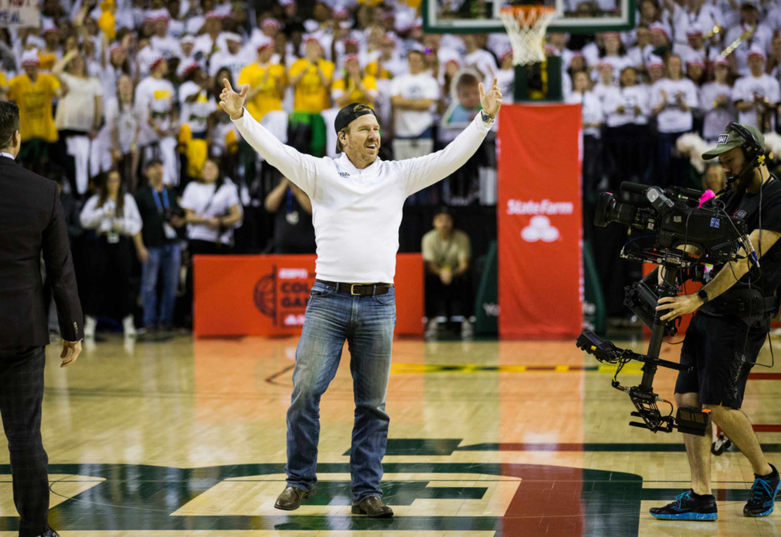 Fixer Upper's Chip Gaines cheers on the court before an NCAA men's basketball game between...