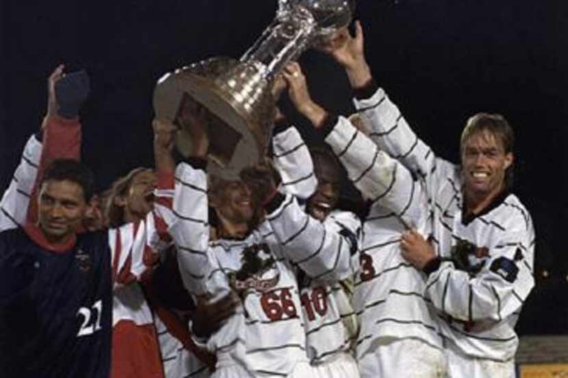 FC Dallas, then the Dallas Burn, lifts the Dewar Challenge Trophy after winning the 1997 US...