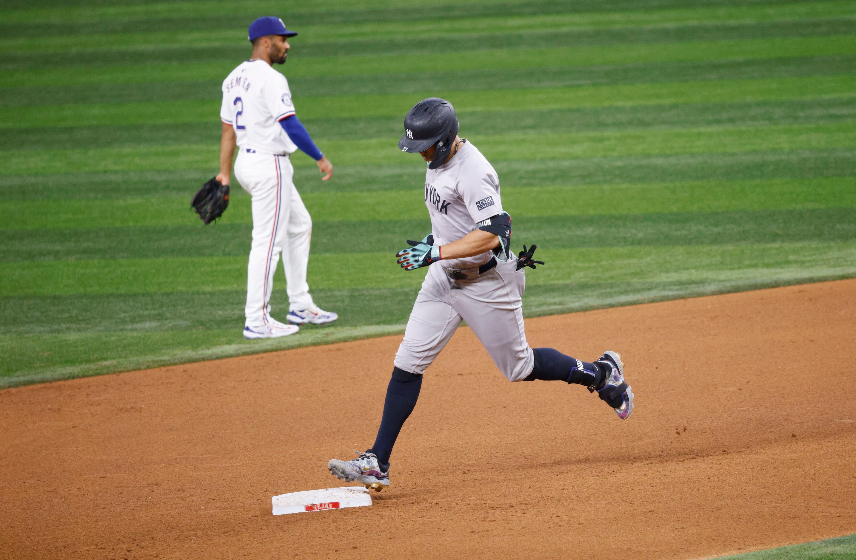 New York Yankees designated hitter Giancarlo Stanton (27) runs the bases after hitting a...