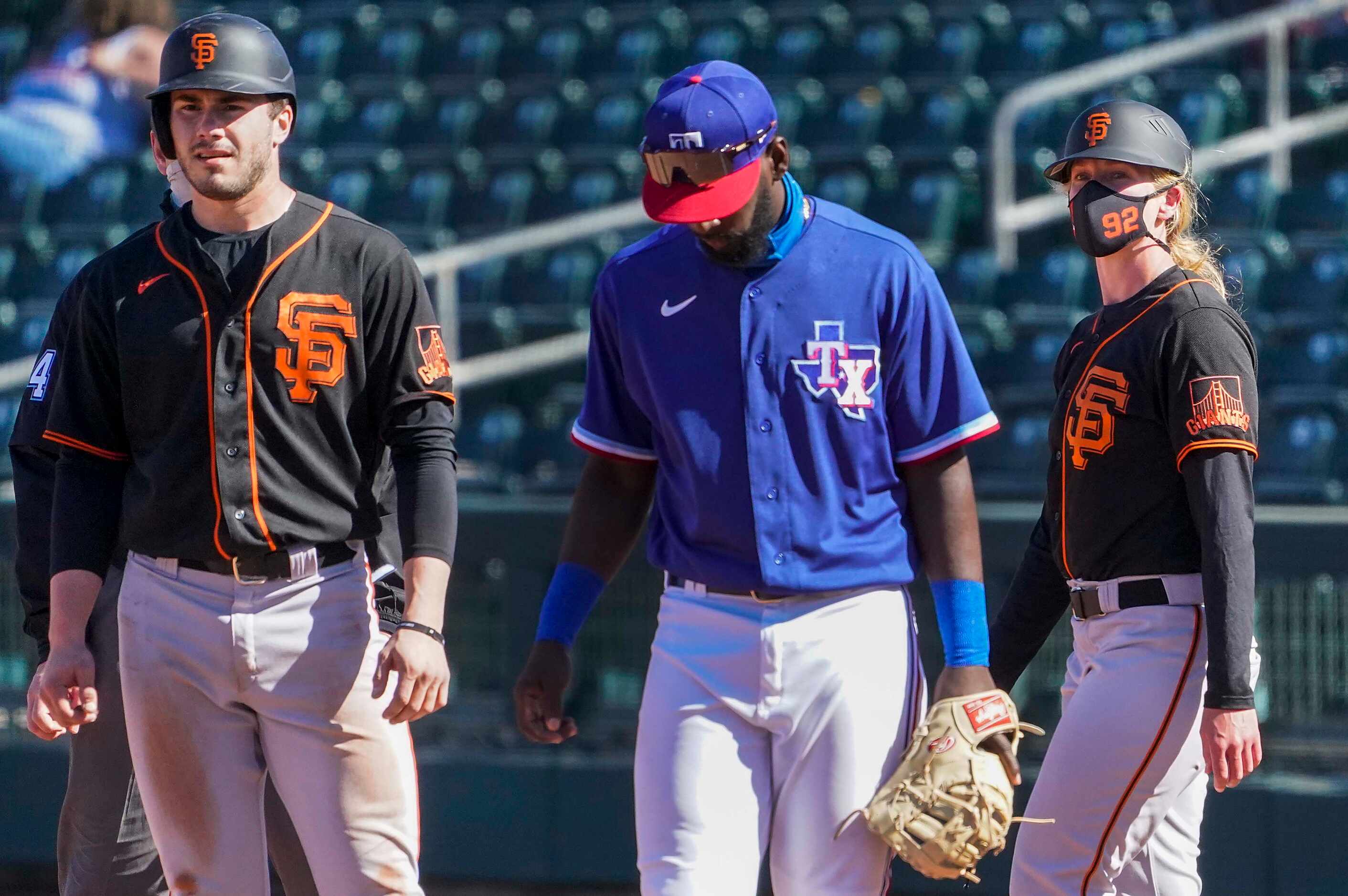 San Francisco Giants assistant coach Alyssa Nakken coaches at first base behind Giants...