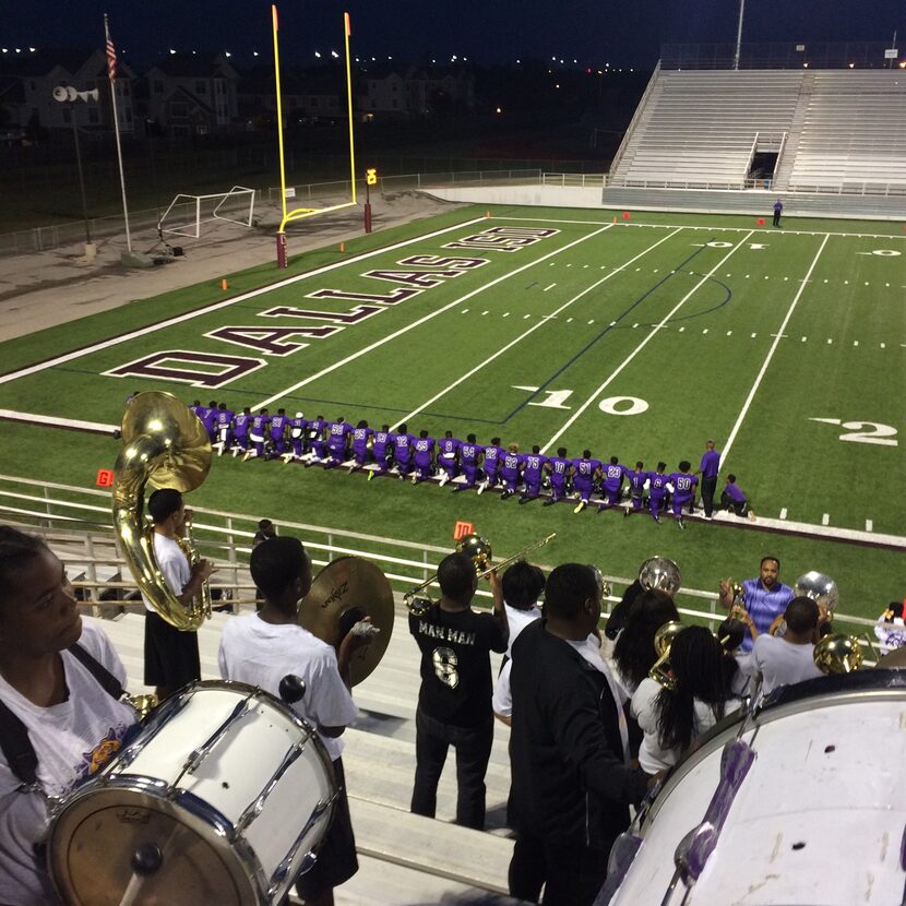 Lincoln HS players kneel before their game Friday night. (Bo Carter) 