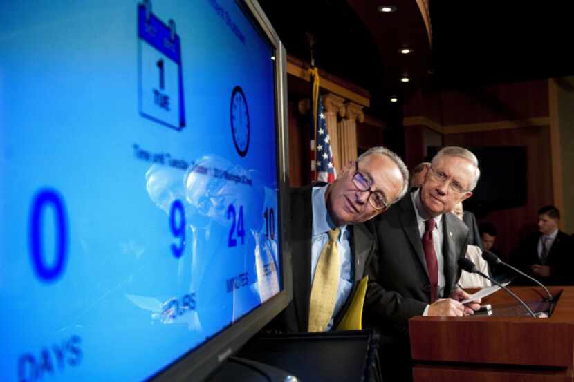Sen. Chuck Schumer, D-N.Y. (left) and Majority Leader Harry Reid, D-Nev., check a clock...