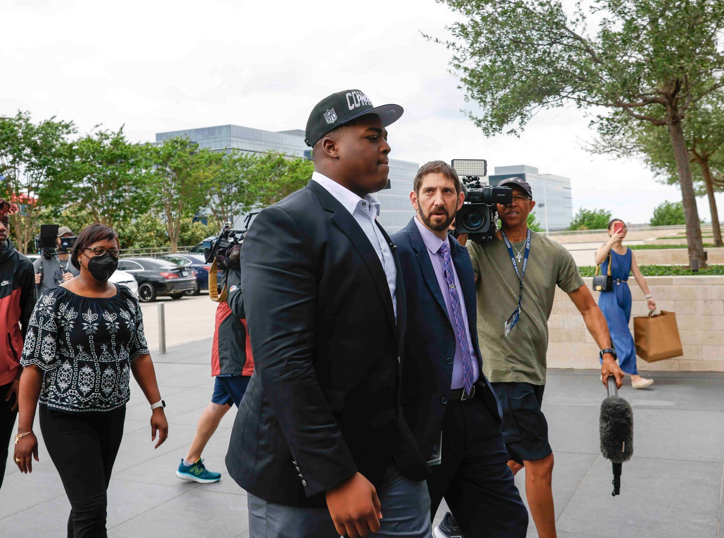 Dallas Cowboys first round draft pick Tyler Smith, left, of Tulsa accompanied by Scott...