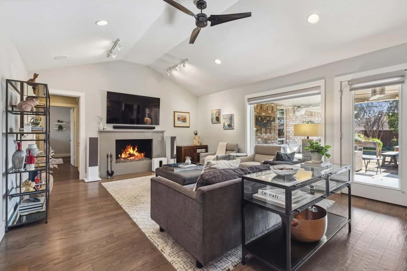 Open living room area with sofa facing a fireplace.